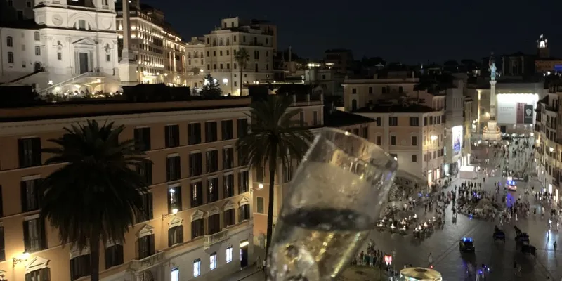 Glass of wine with Spanish Steps in Rome in the background
