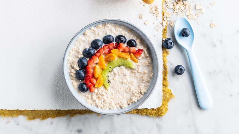 Bowl of porridge with a rainbow of fruit 