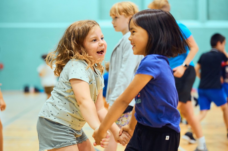 Children dancing in a sports hall