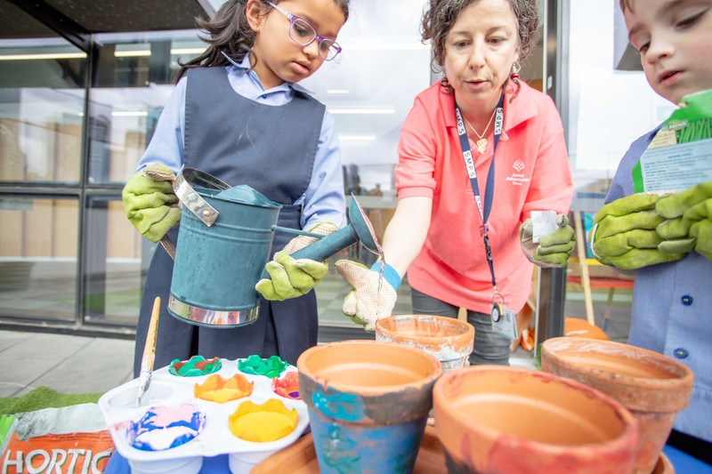 kids outdoors planting pots