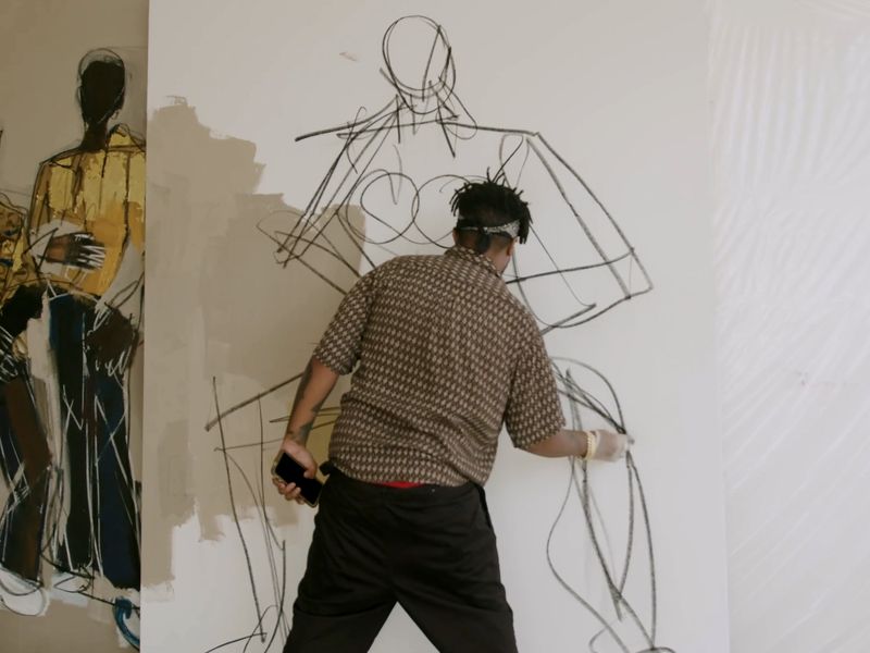 artist Ferrari Sheppard working on his piece in the studio