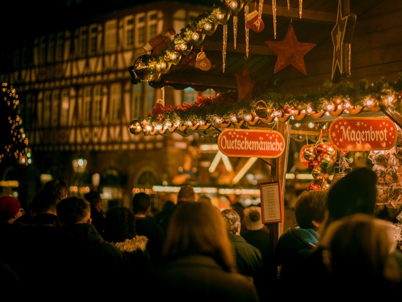 people walking around christmas markets in germany