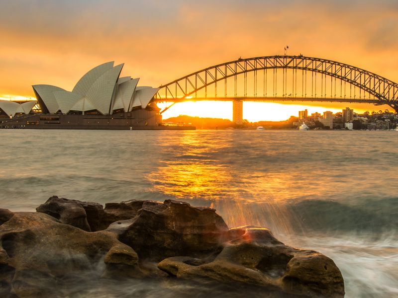 view of sydney australia and its opera house at sunset