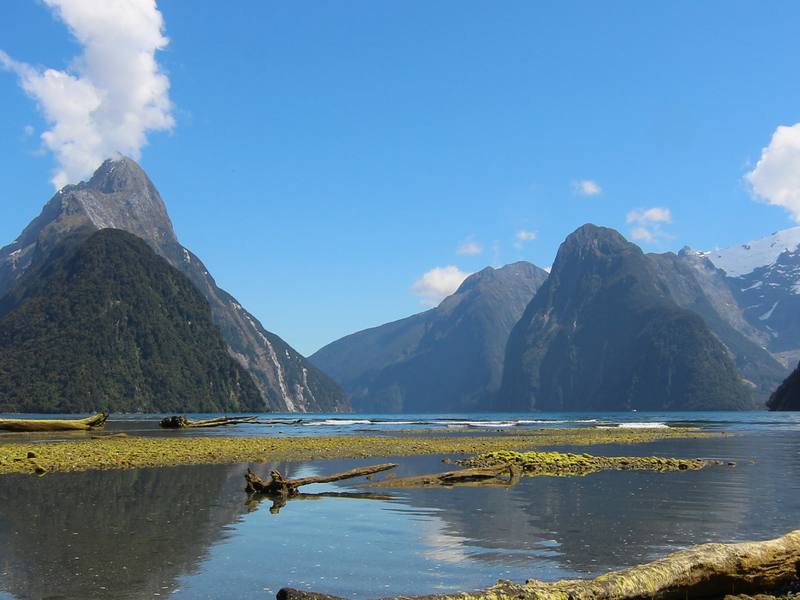 waters of milford sound with cliffs and blue sky
