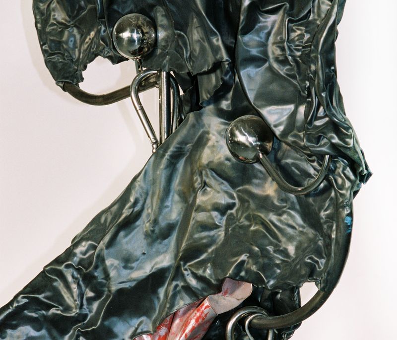large sculpture of dark green crinkled cloth in the artist's studio