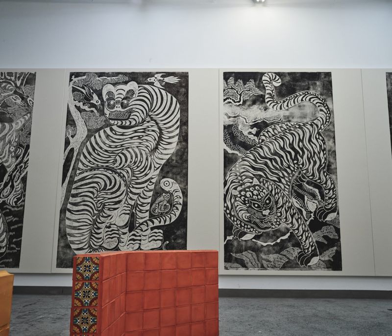 four monochrome, large-scale drawings on a white wall in Kour Pour's studio