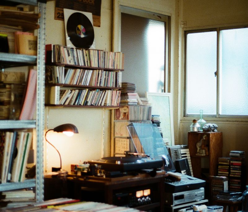 Tomoo Gokita's studio with shelves and music records