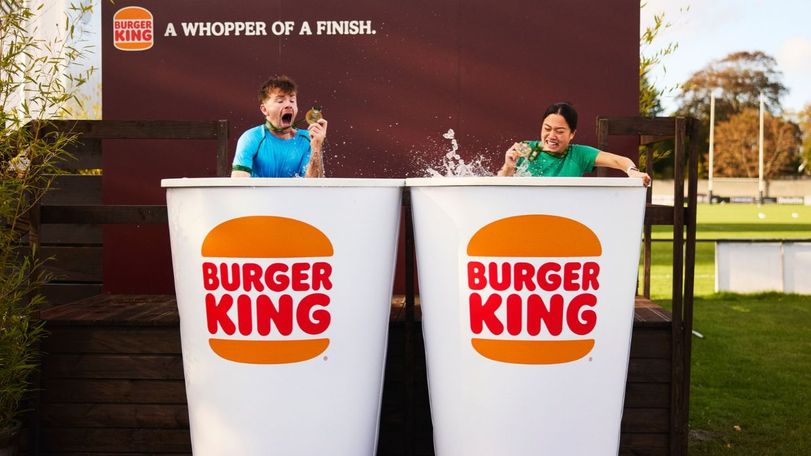 Two people in an ice baths designed as Burger King cups