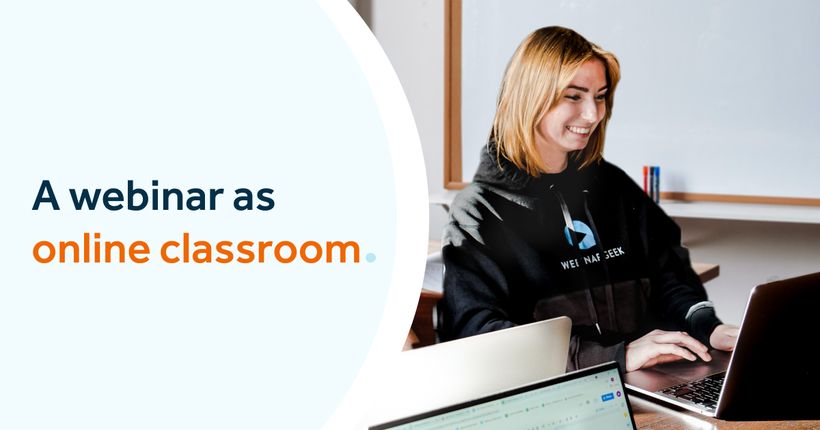 Girl in classroom behind laptop