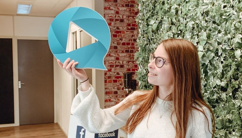 woman looking to a blue play button