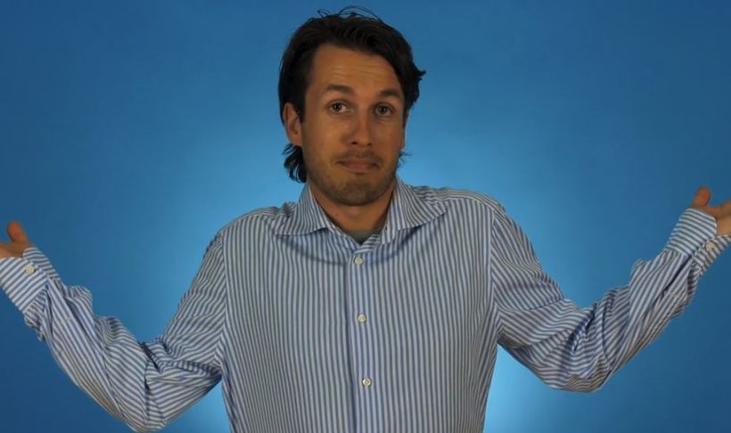 man-shrugging-in-blue-blouse