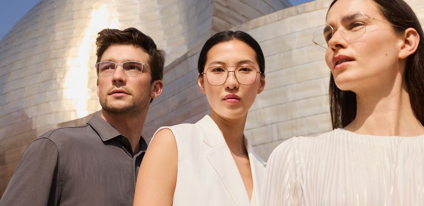 three people wearing Silhouette's titanium eyewear models, standing in front of the Guggenheim Bilbao Museum