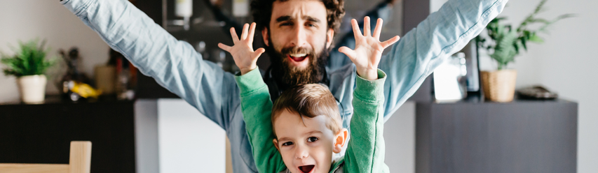 Kid and dad with hands thrown in the air