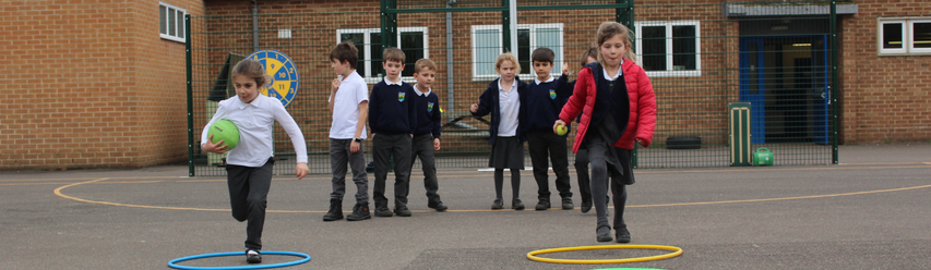 children in school uniform running in playground