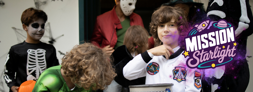 Children in Halloween costumes, including skeleton and astronaut outfits, gather outside a house. "Mission Starlight" logo is visible on the right.