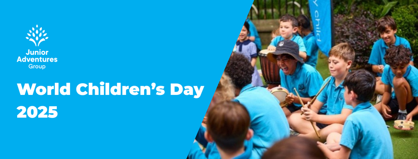 Children in blue shirts sitting outdoors, playing instruments, celebrating World Children's Day 2025. Logo of Junior Adventures Group on the left.