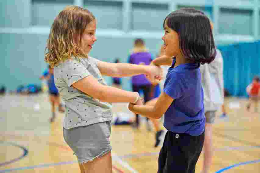 Children dancing in a sports hall