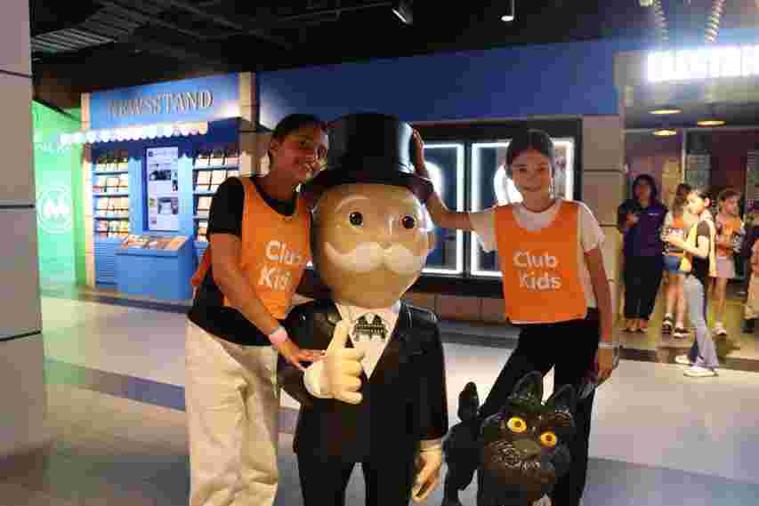 Two children standing with Mr Monopoly at Monopoly Dreams
