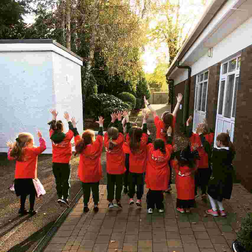 kids with arms thrown in the air