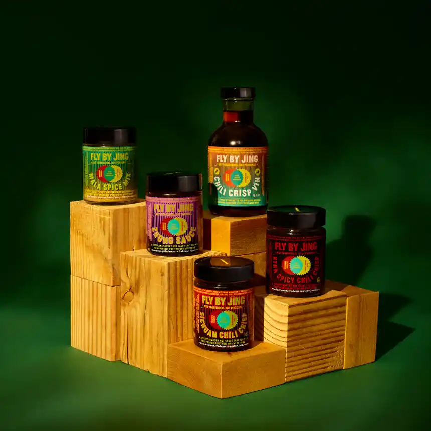 line up of Fly By Jing sauces on wooden blocks