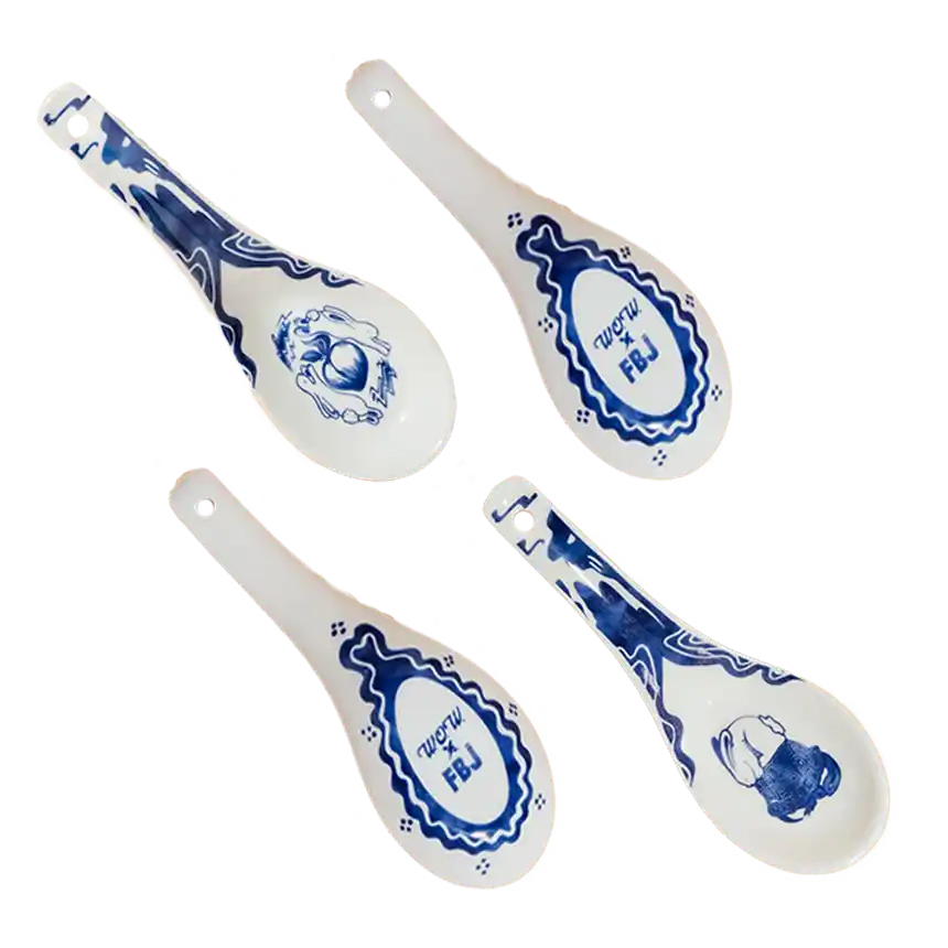 Four cream-colored ceramic spoons with blue designs