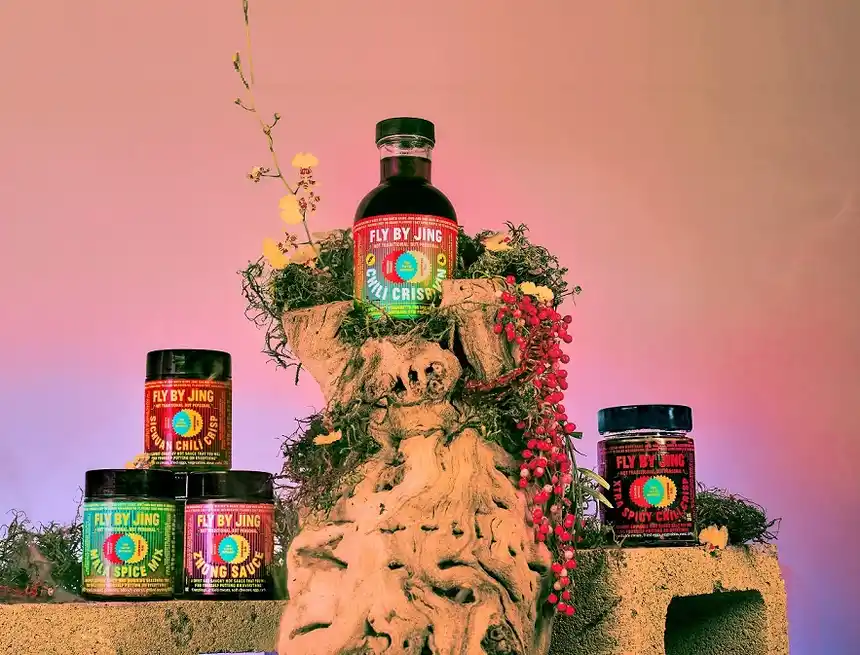 line up of Fly By Jing sauces on a wooden pedestal