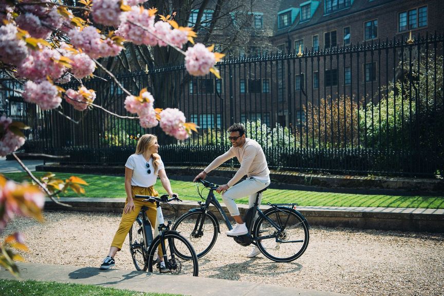 Man and Woman sitting on bikes talking