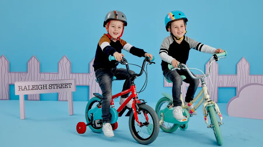 Twins riding Raleigh Pop kids bikes with stabilisers 