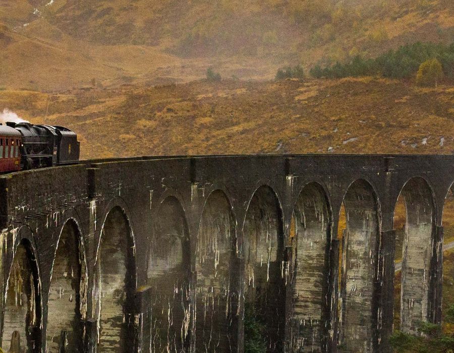 people riding a train in Scotland