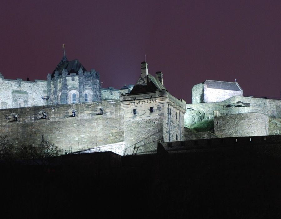edinburgh castle lit up at night in scotland
