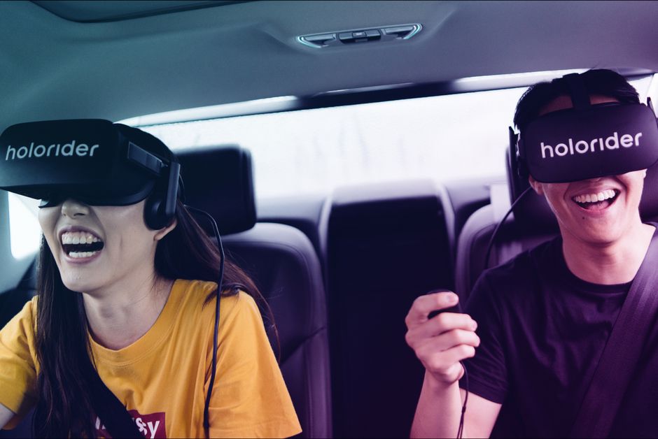 Two passengers with VR headsets enjoying their first holoride
