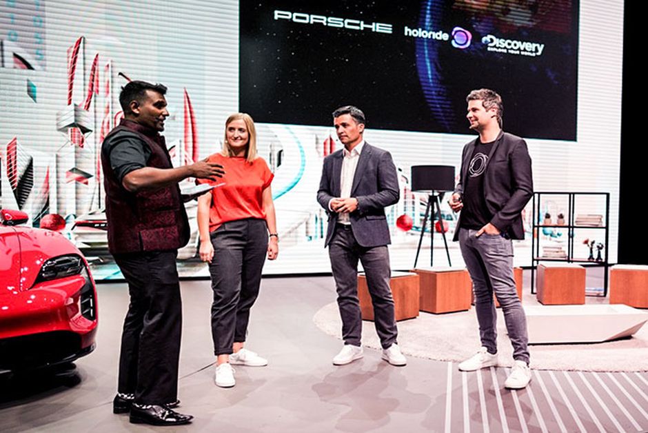 Nils, Alberto Horta (Discovery) and Anja Mertens (Porsche) standing on a stage during Porsche Innovation Day at IAA