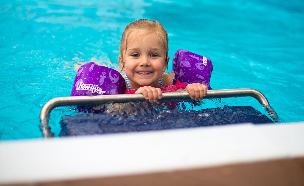 Picture of a young girl in floaties in a traditional pool with a Fastlane Pro