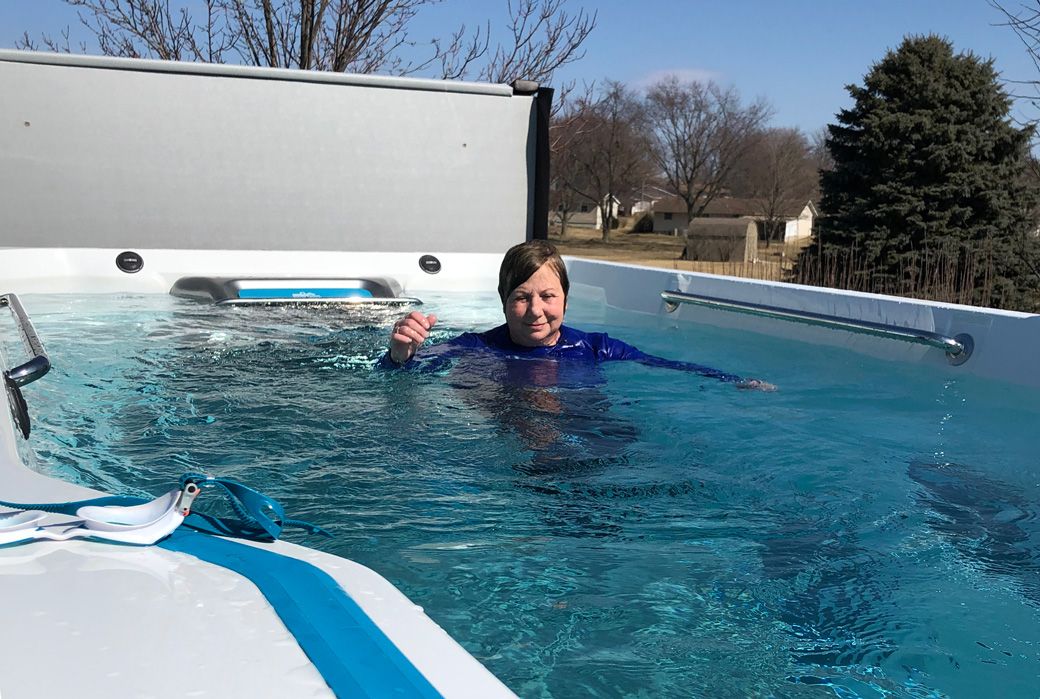 picture of woman using Endless Pools swim spa as arthritis therapy pool