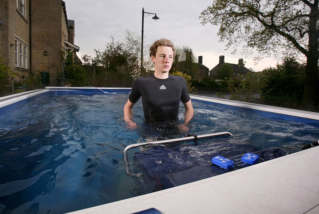 A picture of a man running against the current on an underwater treadmill.
