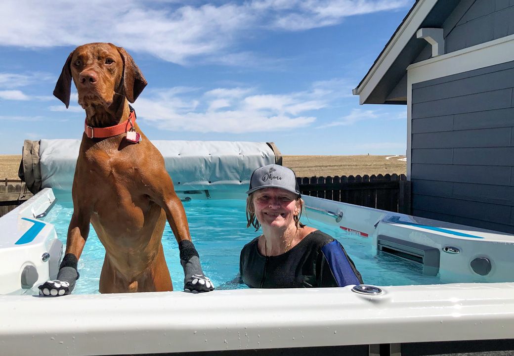 picture of woman and dog in Endless Pools X500 swim spa