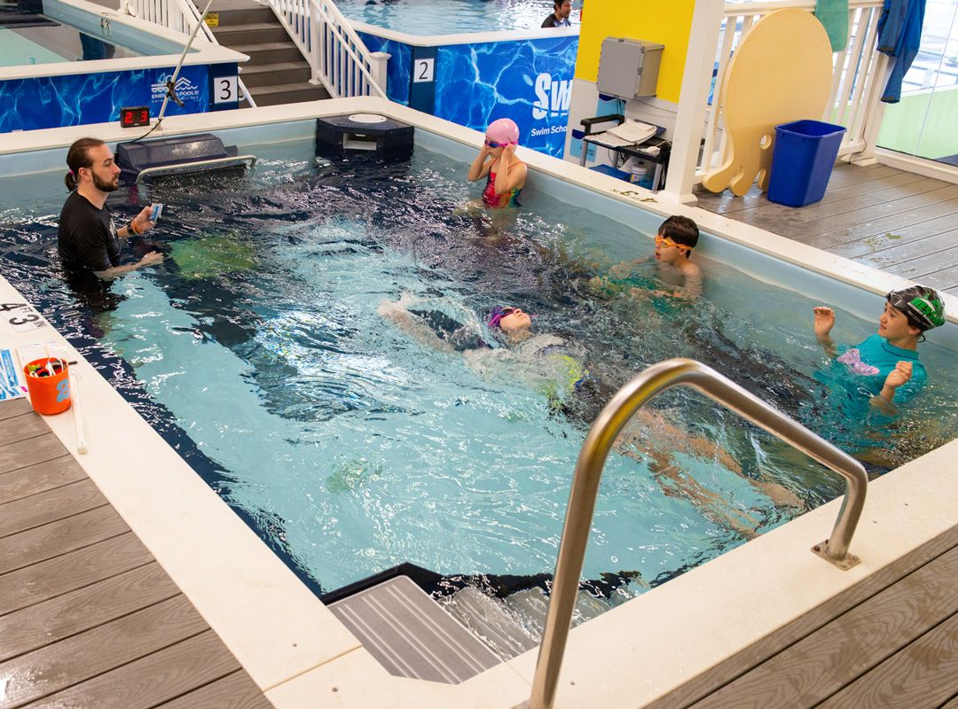 Group swim instruction in an Endless Pools commercial model at SwimLabs