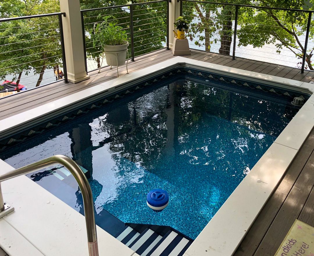 A picture of a fully in-ground WaterWell pool installed on a deck.