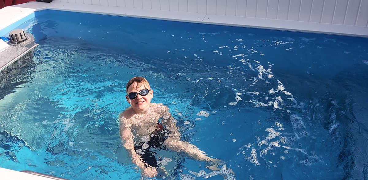 picture of a boy in an Endless Pools backyard pool