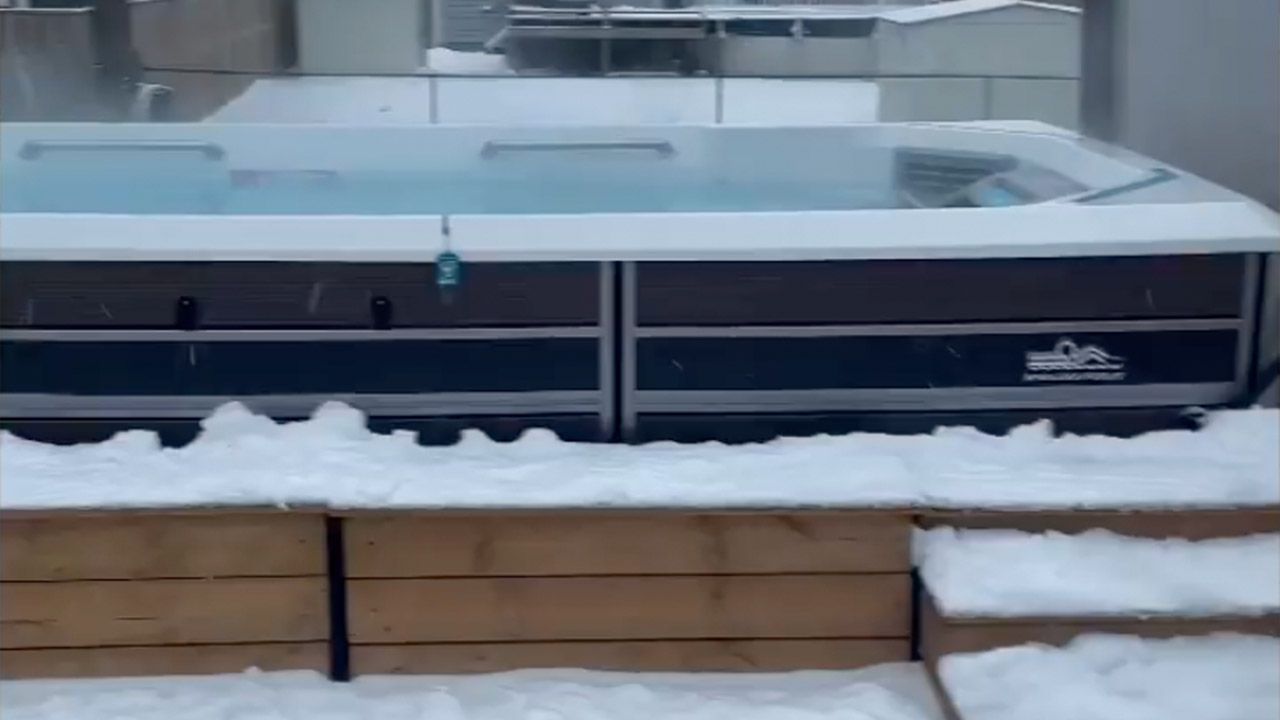 Video of a man swimming in a snowstorm