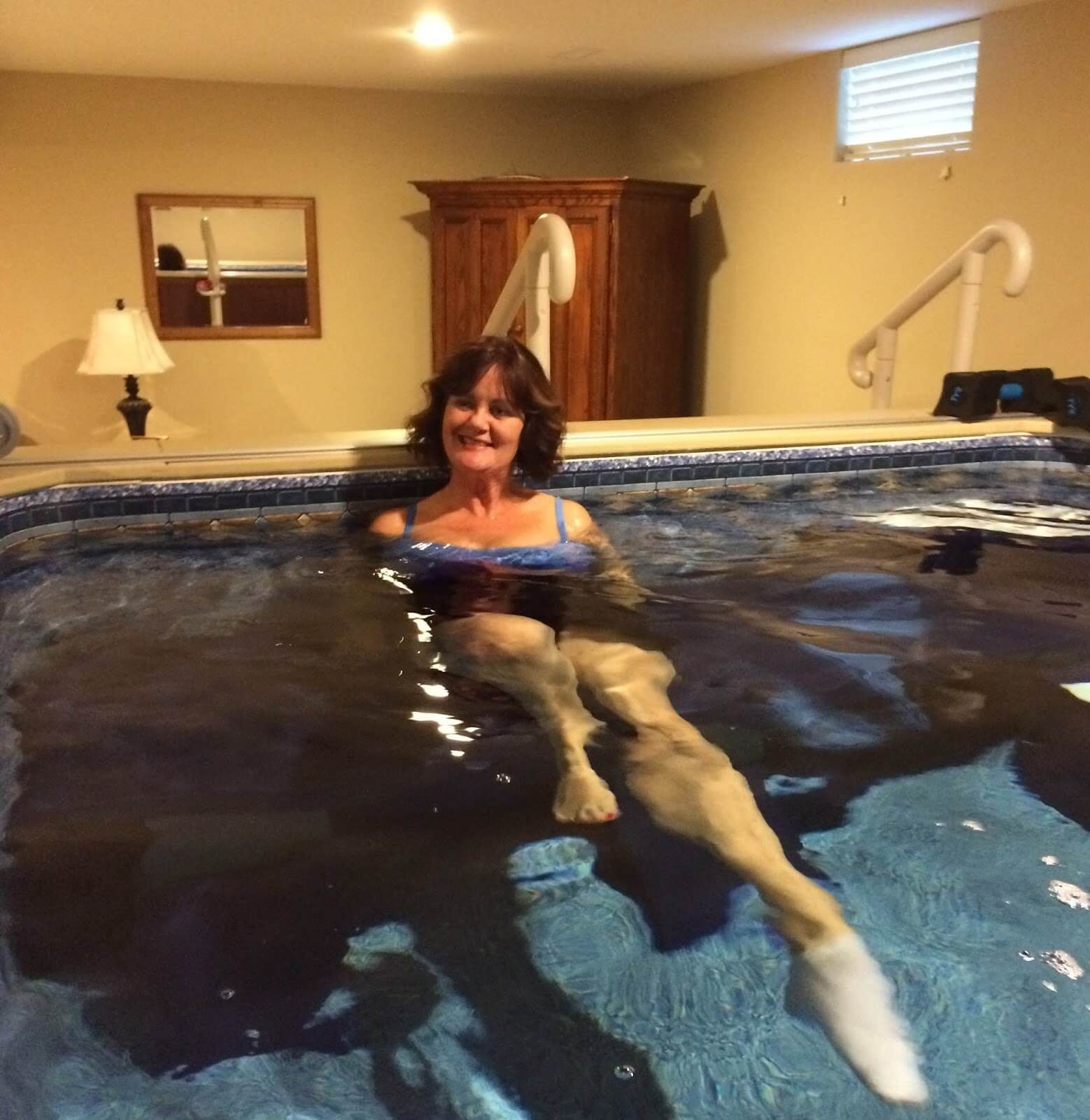 Deborah doing aquatic therapy exercises in her Endless Pools WaterWell