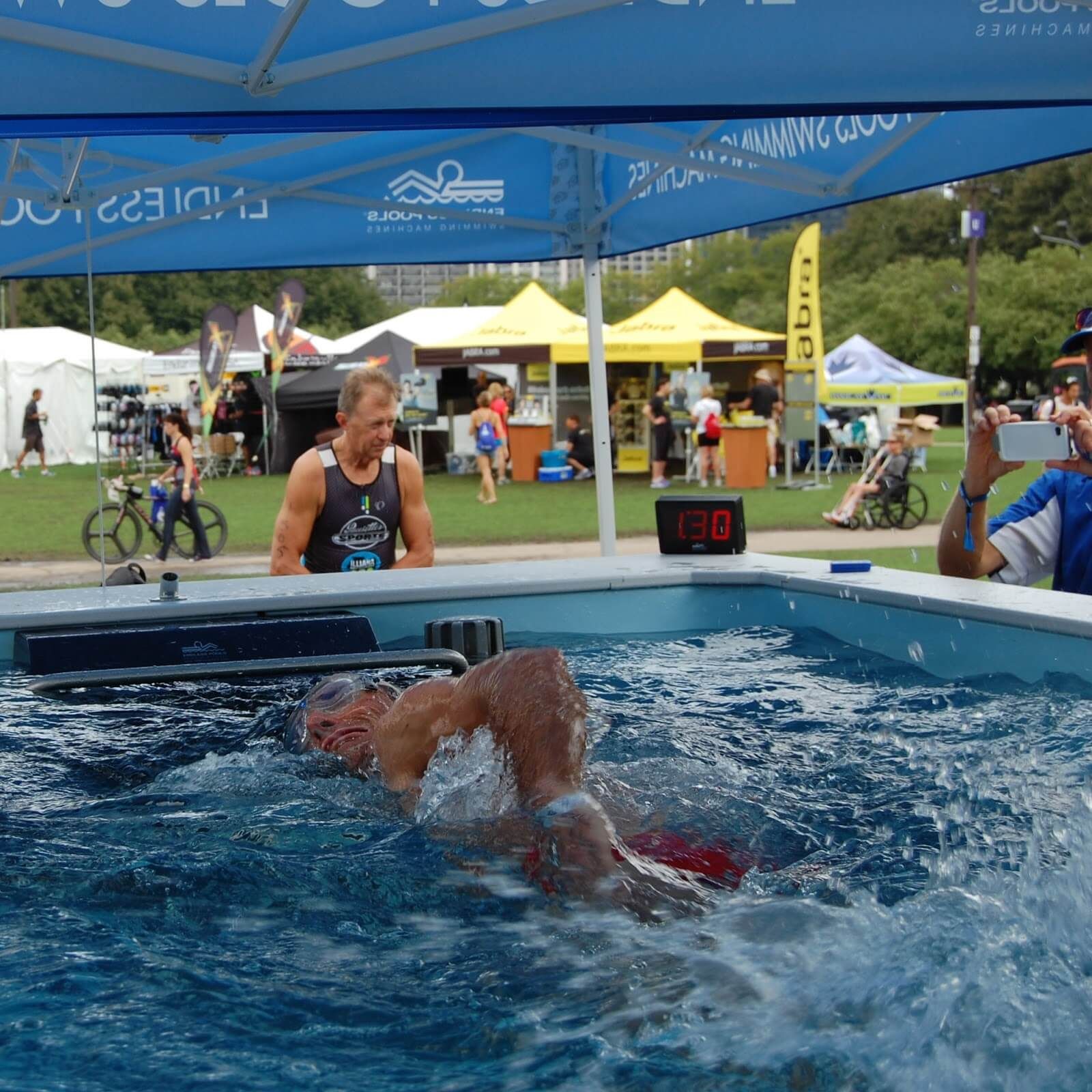 picture of a triathlete swimming in the Endless Pool at a triathlon expo