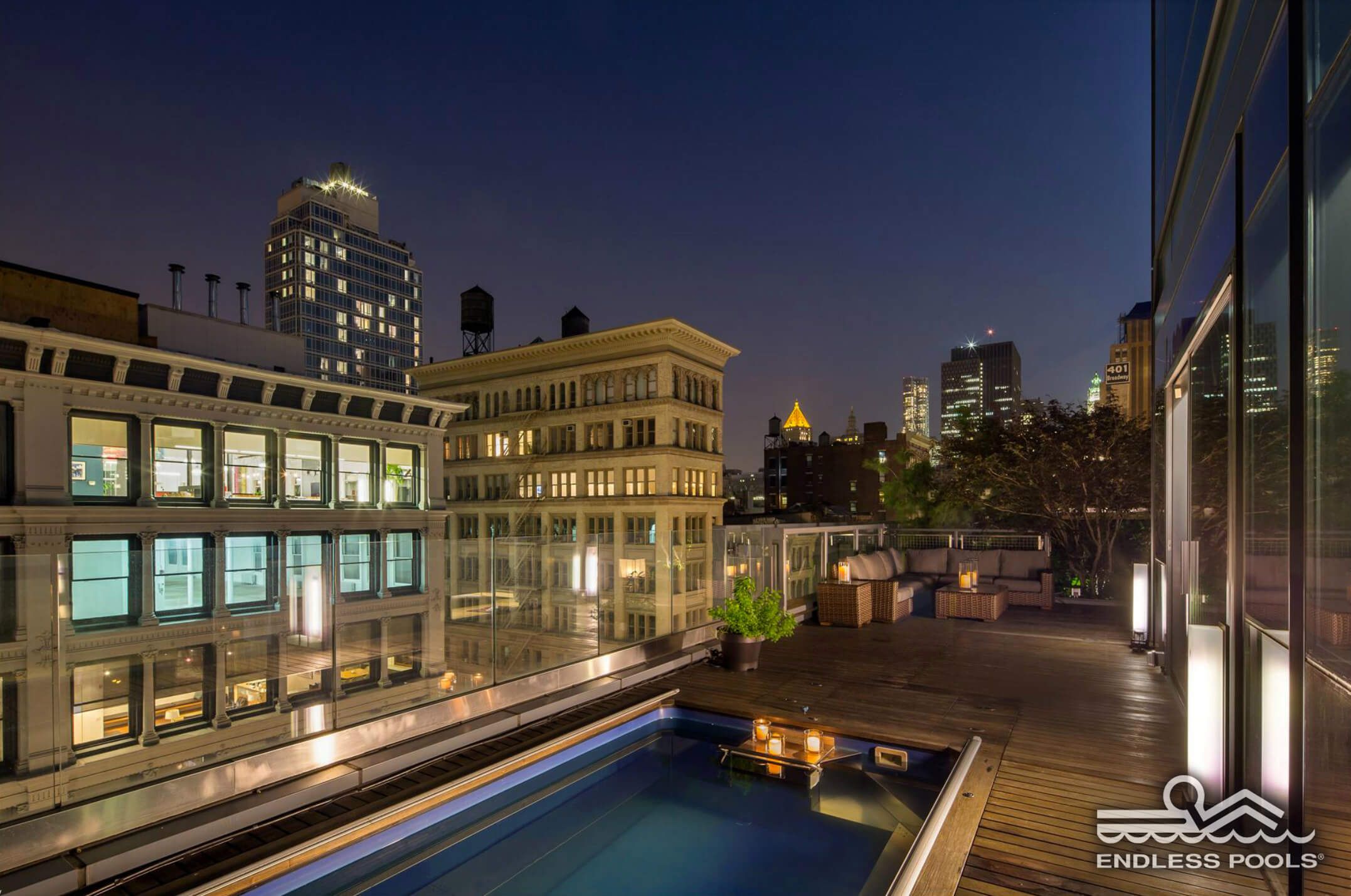 a rooftop Endless Pool at night in New York City's SoHo district