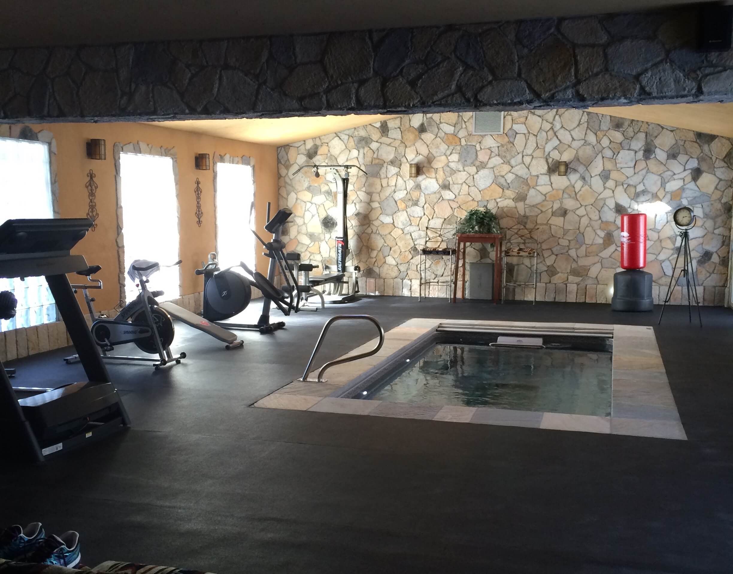 picture of a fully in-ground Original Endless Pool in a pain cave in a New York City suburb