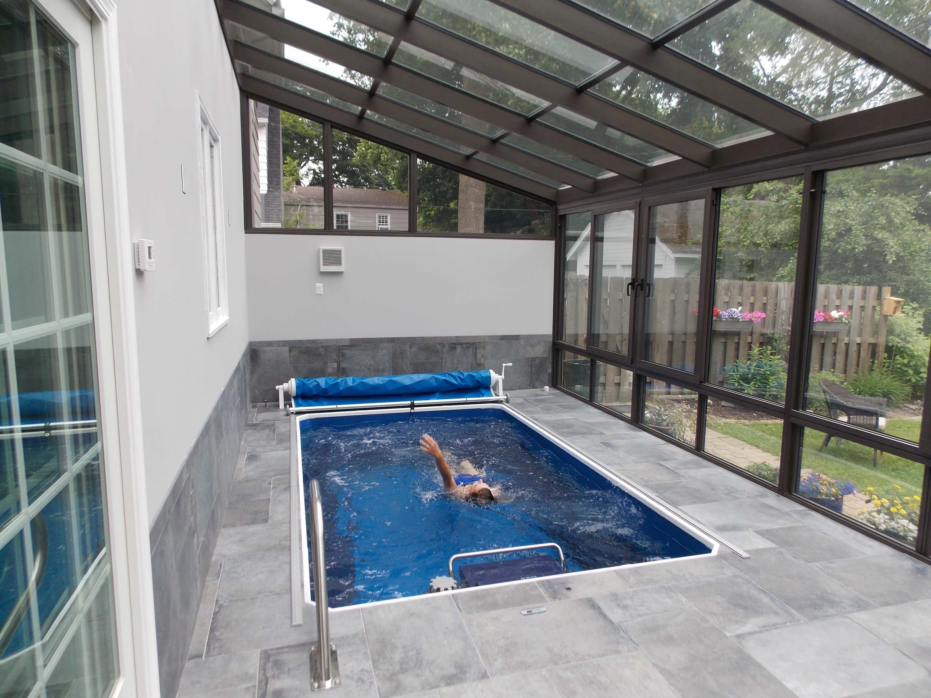 a fully in-ground Endless Pool in a pool enclosure in Rochester, New York