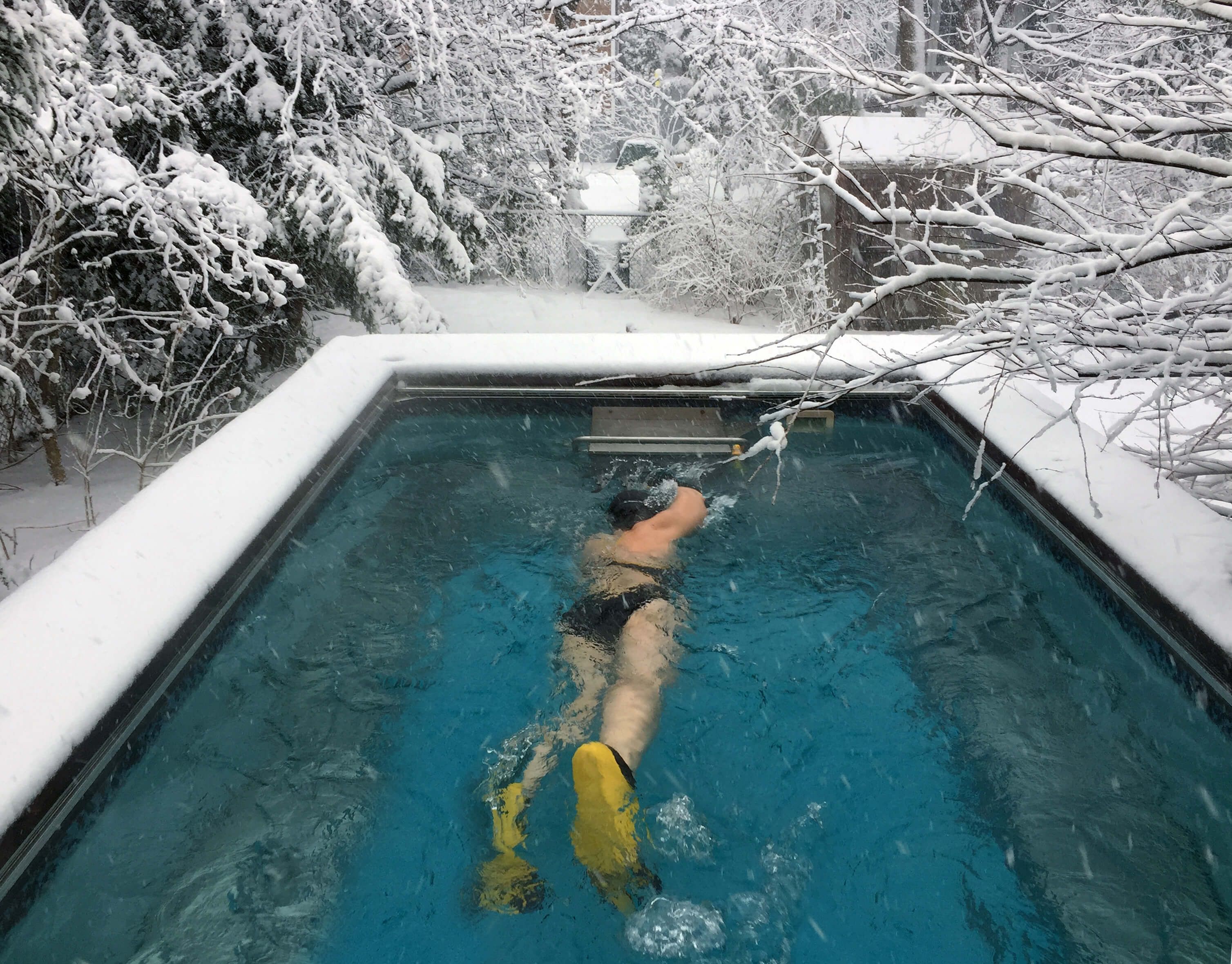 picture of a swimmer in an outdoor Original Endless Pool after a New England snowfall