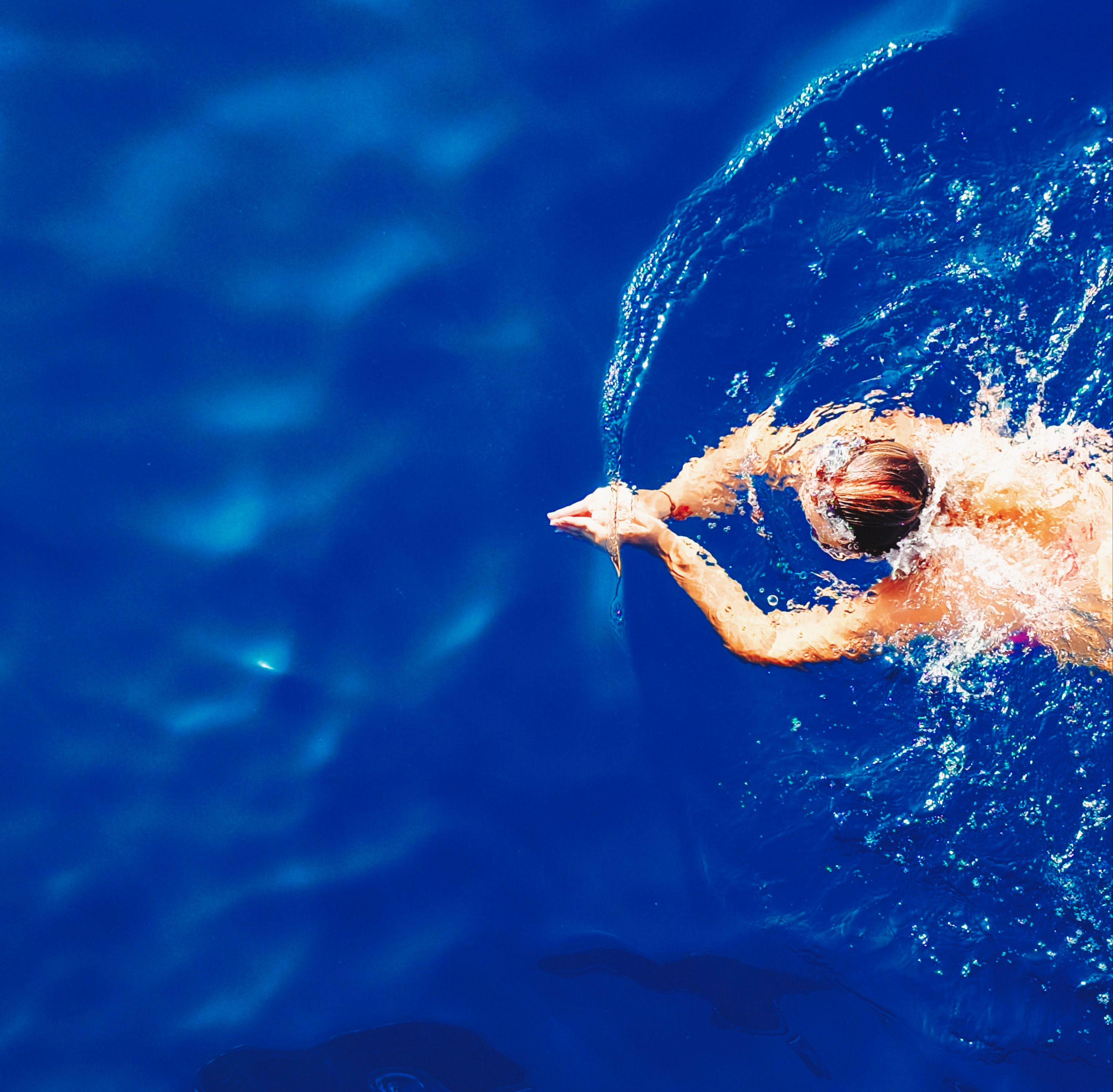 picture of a woman swimming, viewed from above