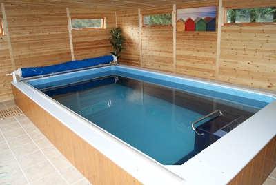 an Endless Pools swimming machine in an enclosure by Bakers Timber Buildings