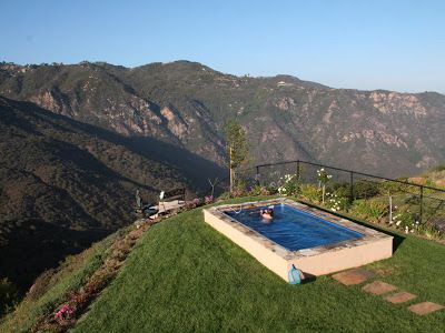 A hillside Endless Pools swimming machine installed partially in-ground