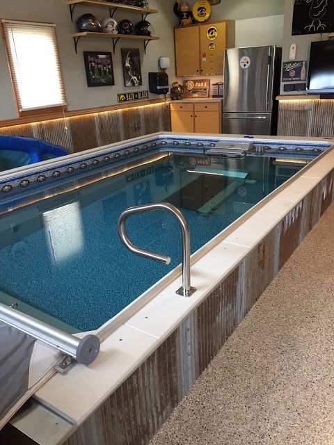 an indoor Endless Pools swimming machine near a kitchenette